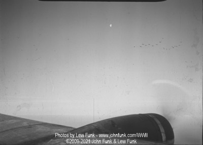 Formation of B-17s silhouetted by the Moon setting over the English Channel on Mission to Berlin February 3, 1945