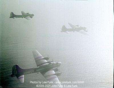 B-17s including 44-8235 <q>Mikkey</q> Returning over water from Berlin February 3, 1945 - Color
